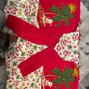 Matching family Christmas pjs with dog bandana tropical Santa under palm tree